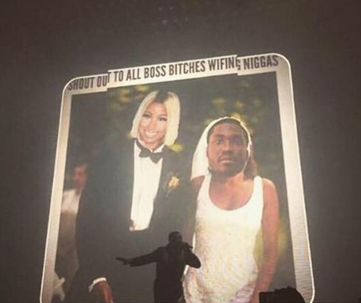Drake performs at the 2015 OVO Fest in front of a jumbo screen with an altered photo featuring the faces of Nicki Minaj and Meek Mill